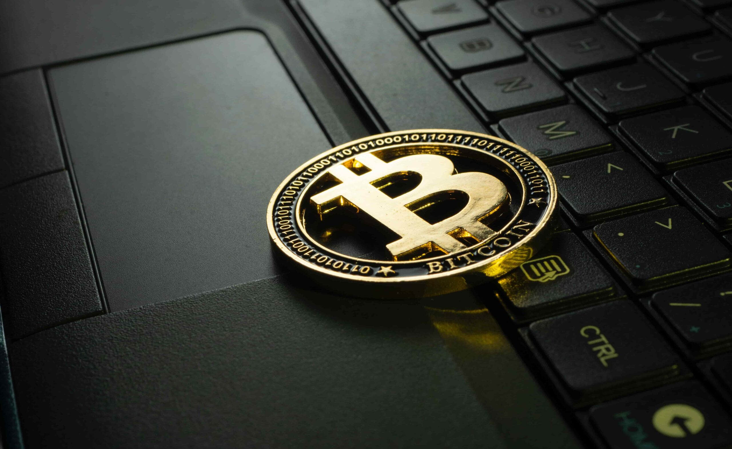 A bitcoin on a laptop.